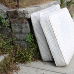 Old,discarded,mattress,left,outside,in,urban,alleyway